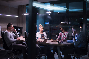 Image showing Multiethnic startup business team in night office