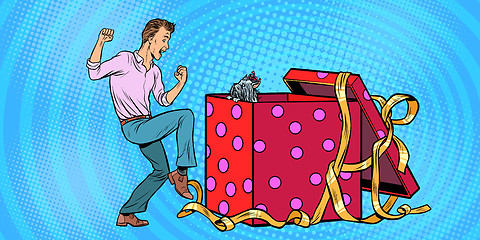 Image showing Man and dog puppy as a gift holiday box, funny reaction joy