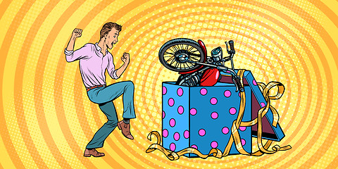 Image showing Man and motorcycle holiday gift box, funny reaction joy.