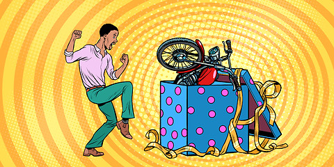 Image showing african Man and motorcycle holiday gift box, funny reaction joy.