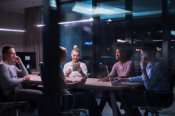 Image showing Multiethnic startup business team in night office