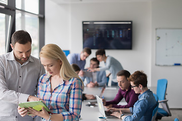 Image showing Two Business People Working With Tablet in office