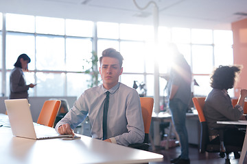 Image showing businessman working using a laptop in startup office