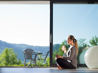 Image showing young woman doing morning yoga exercises