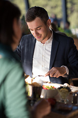 Image showing Closeup shot of young woman and man having meal.