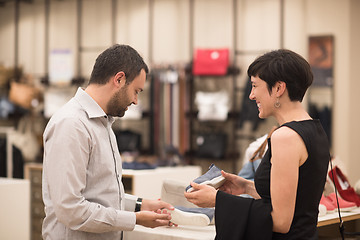 Image showing couple chooses shoes At Shoe Store