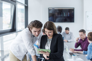 Image showing Two Business People Working With Tablet in office