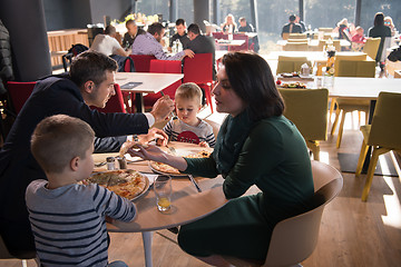 Image showing Young parents enjoying lunch time with their children