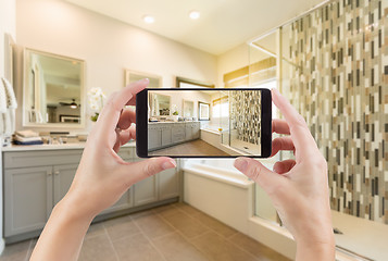 Image showing Master Bathroom Interior and Hands Holding Smart Phone with Phot