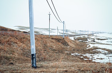 Image showing Winter field with power line columns