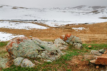 Image showing Steppe with colorful stones at the winter mountains