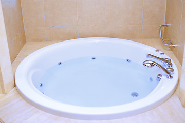 Image showing Modern bathtub full of water
