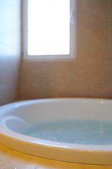 Image showing Modern bathroom with bathtube full of water