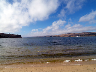 Image showing wide angle view of small cove with water and clouds