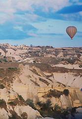 Image showing Hot air balloon flying over the rocks of Cappadocia