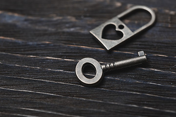 Image showing Vintage bronze lock and key on a wooden table