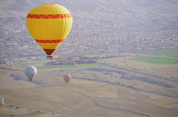 Image showing Three air balloons flying over the land