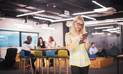 Image showing blonde businesswoman working online using digital tablet