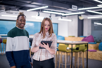 Image showing multiethnic business couple using a tablet computer