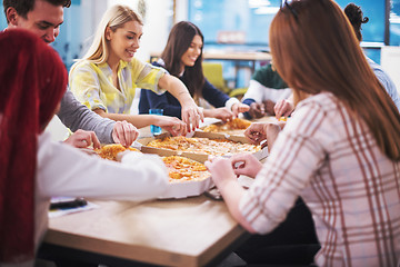 Image showing multiethnic business team eating pizza