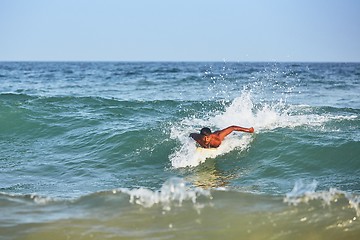 Image showing Young man surfing in sea