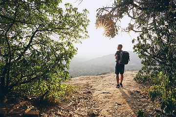 Image showing Hiker overlooking view from rock