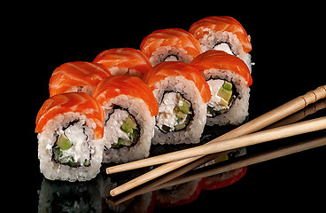 Image showing Sushi rolls Philadelphia with chopsticks