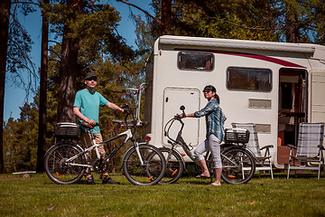 Image showing Woman with a man on electric bike resting at the campsite.