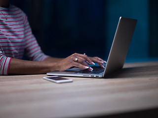 Image showing black businesswoman using a laptop in startup office