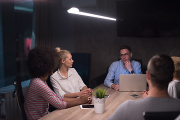 Image showing Multiethnic startup business team in night office