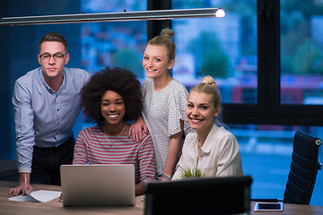 Image showing Multiethnic startup business team in night office