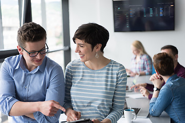 Image showing Two Business People Working With Tablet in office