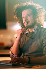 Image showing man working on computer in dark office