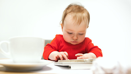 Image showing Happy child baby girl toddler sitting with keyboard of computer isolated on a white background