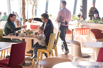 Image showing Young parents enjoying lunch time with their children