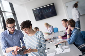 Image showing Two Business People Working With Tablet in office