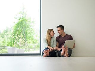 Image showing couple using laptop on the floor at home