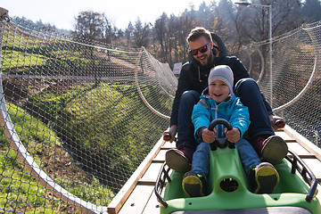 Image showing father and son enjoys driving on alpine coaster