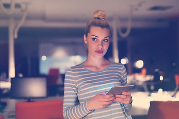 Image showing woman working on digital tablet in night office