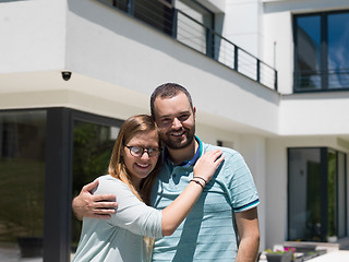 Image showing couple hugging in front of  new luxury home