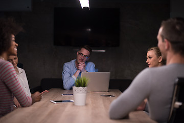 Image showing Multiethnic startup business team in night office