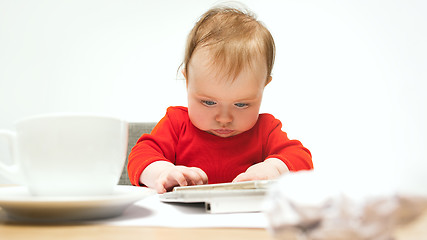 Image showing Happy child baby girl toddler sitting with keyboard of computer isolated on a white background