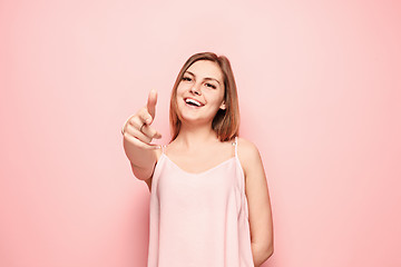 Image showing The happy woman point you and want you, half length closeup portrait on pink background.