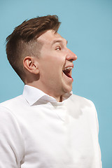 Image showing The happy business man standing and smiling against studio background.