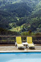 Image showing Long chairs by the pool 2