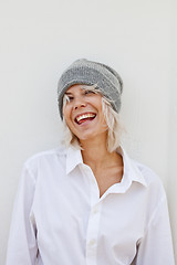 Image showing Beautiful happy young woman in warm grey beanie.