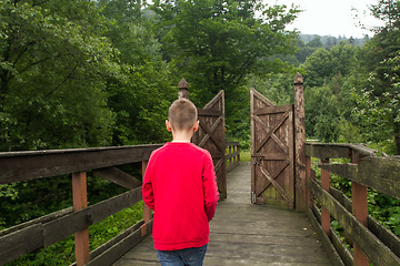 Image showing Boy Goes Through the Gates to a New Life