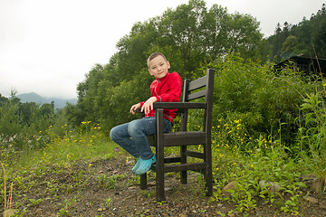 Image showing Boy Sitting on Chair in the Forest