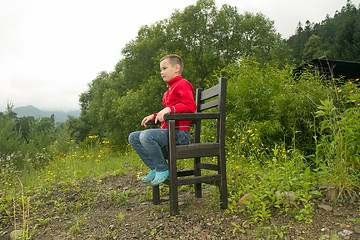 Image showing Boy Sitting on Chair in the Forest