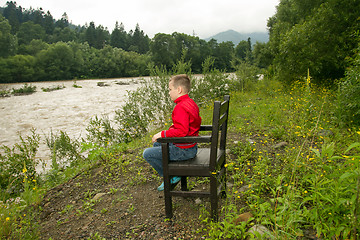 Image showing Boy Sitting on Chair in the Forest